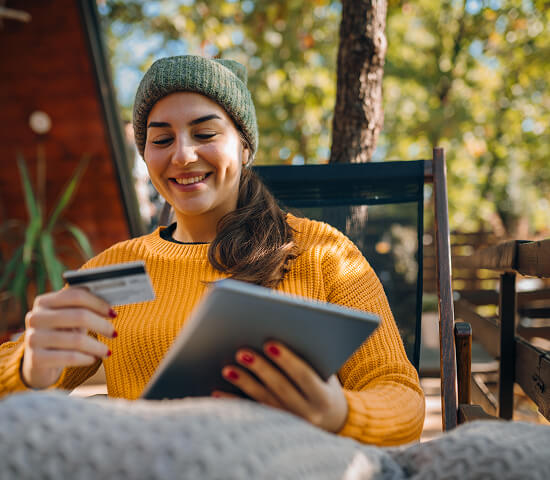 woman with card and tablet in hand
