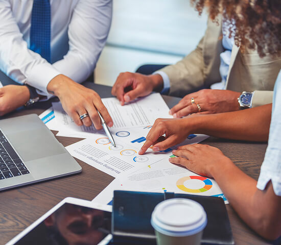 group looking at graphs in business setting