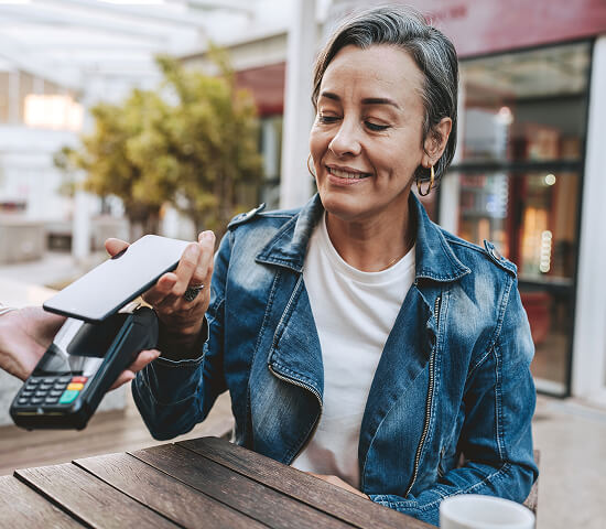 woman using tap payment with phone