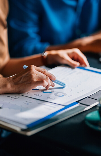 person holding graphs and documents